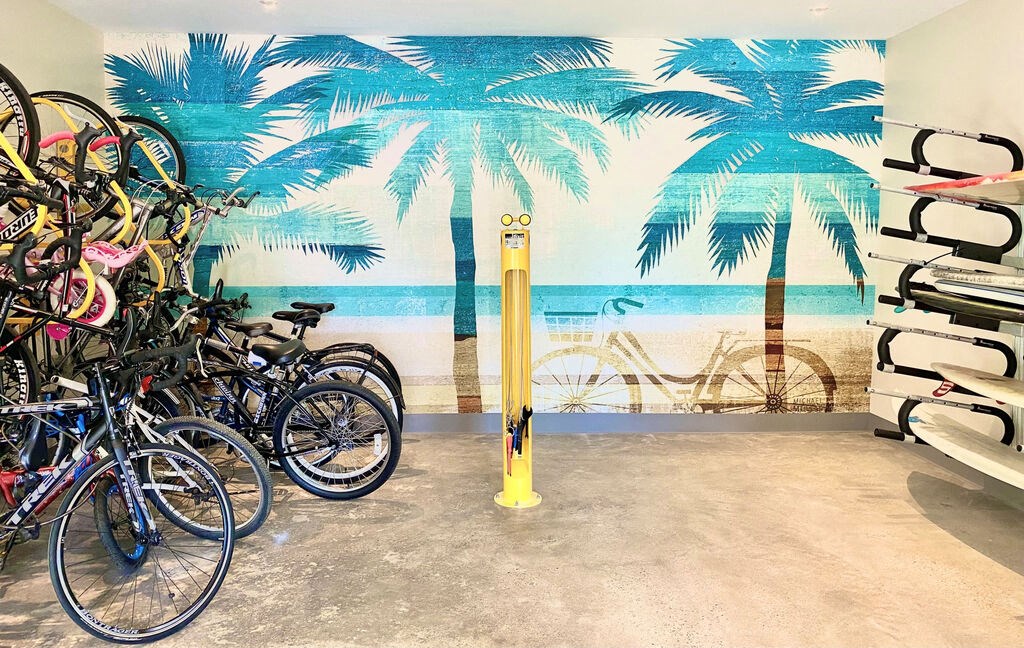 a group of bikes parked in front of a wall mural of a beach with palm at La Jolla Blue, San Diego, CA