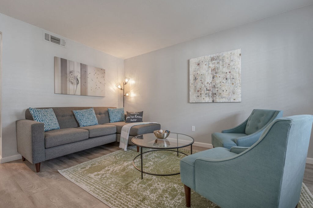 a living room with a couch and two chairs at Napa Green Apartments LLC, Napa