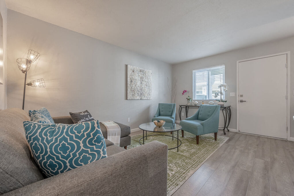 a living room with a couch and chairs and a table