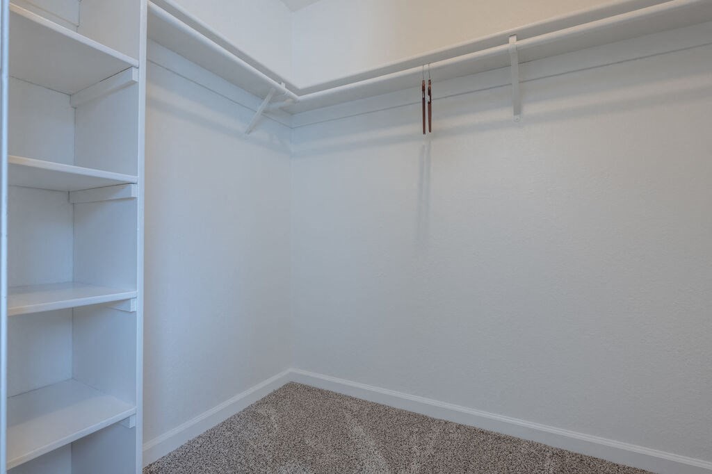 a walk in closet with white walls and shelves at Napa Green Apartments LLC, Napa, CA
