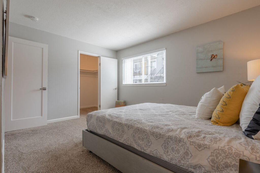 a bedroom with a bed and a door to a closet  at Napa Green Apartments LLC, Napa, CA 94559
