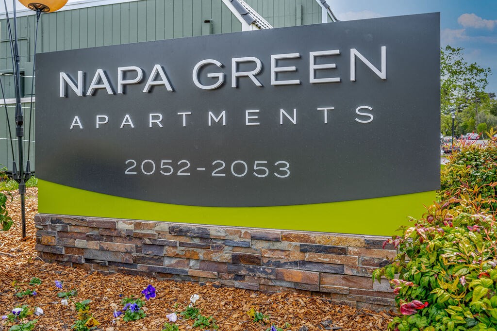 a sign for napa green apartments in front of a building at Napa Green Apartments LLC, Napa, CA 94559