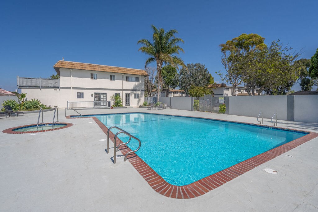 a swimming pool at a resort with a building in the background at Ocean Villas, Oxnard California