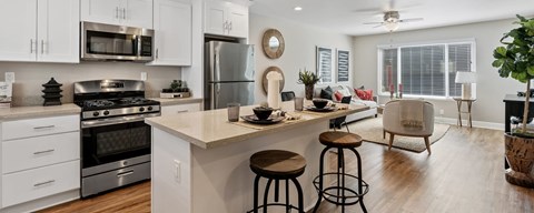 A modern kitchen with white cabinets and a large island.