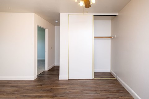 A room with a white door and a white wall.