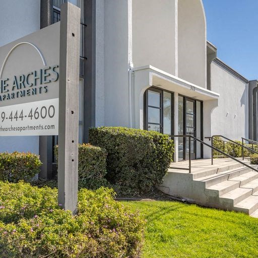 a building with stairs and a sign in front of it at The Arches Apartments, El Cajon, CA