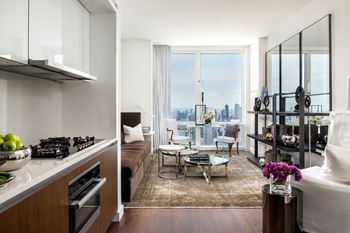 A modern kitchen with a view of the city at SKY Apartments, New York, New York