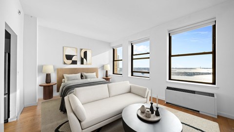 A bedroom with a large bed and a couch.