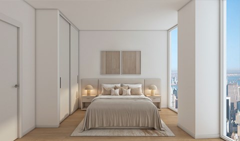 A bedroom with a large bed and a city view.