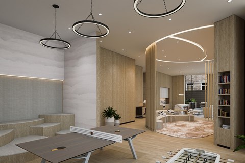 A modern living room with a large table and a bookshelf.