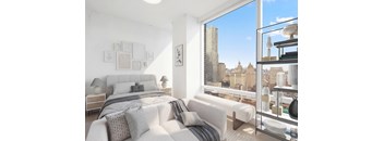 A bedroom with a large bed and a view of the city.