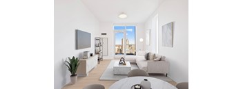 A modern living room with a large window and a flat screen TV mounted on the wall.