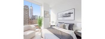 A bedroom with a large bed and a view of the city.
