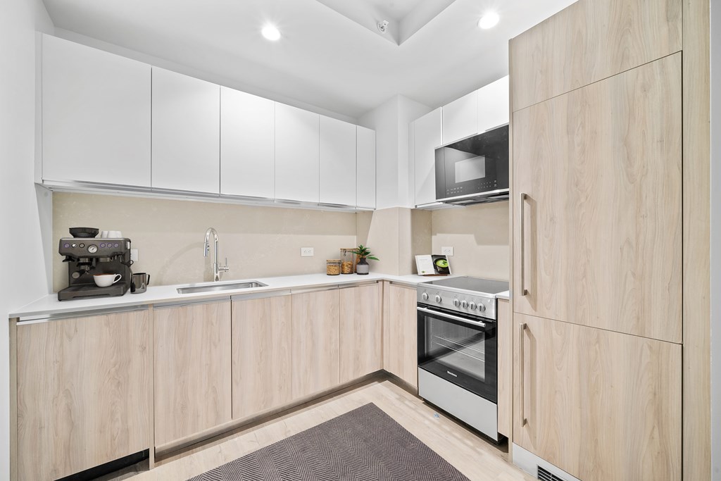 A kitchen with wooden cabinets and a white countertop.