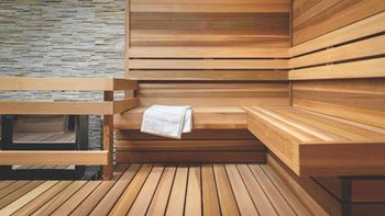 a sauna with wooden steps and a white towel at SKY Apartments, New York