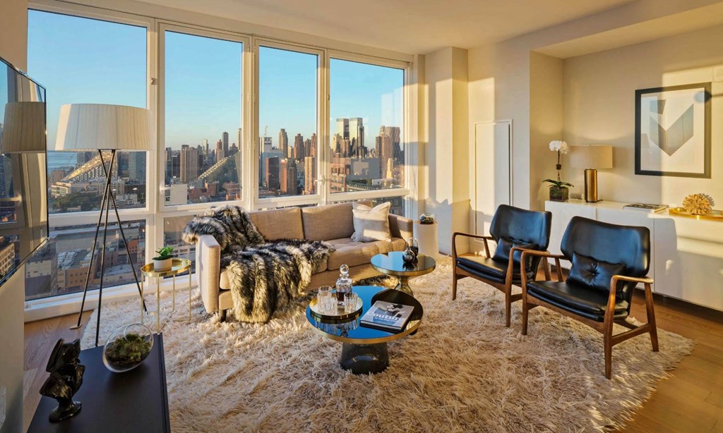 the living room of an apartment with a view of the city at SKY Apartments, New York, New York