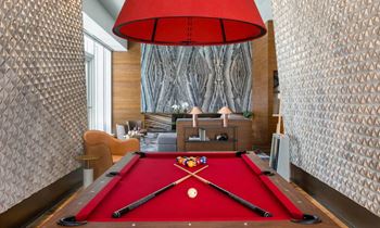 a pool table in a living room with a red pool at SKY Apartments, New York