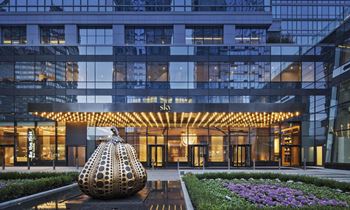 a large building with a sculpture in front of it at SKY Apartments, New York, New York