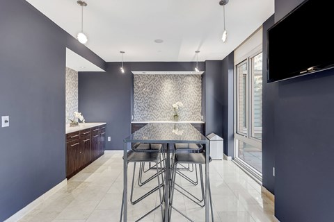 A modern kitchen with a dining table and chairs.
