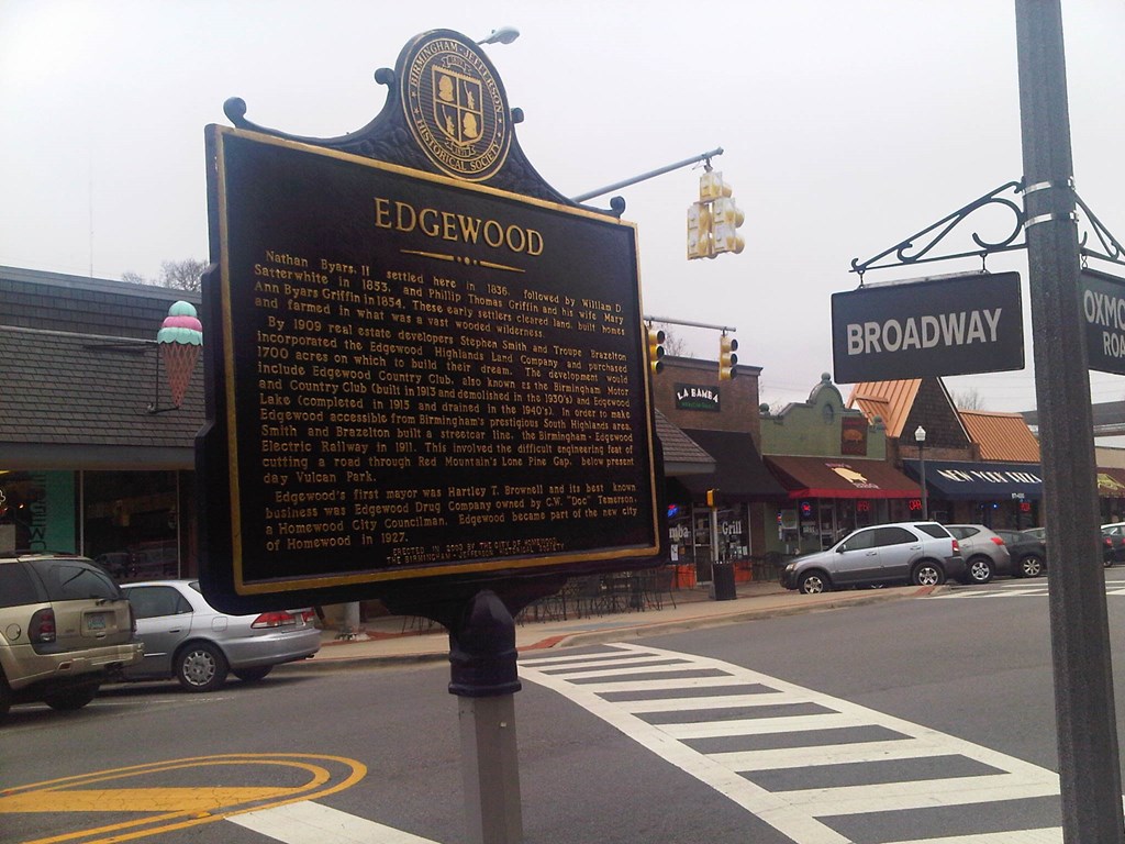 a historical sign on the side of a city street