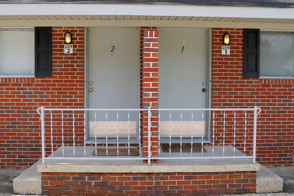 a brick building with two doors and a ramp