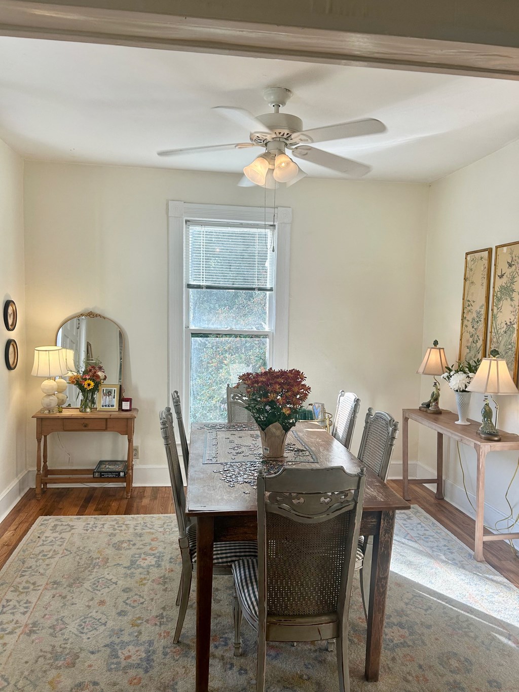 a dining room with a table and chairs and a ceiling fan