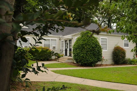 a white house with a sidewalk in front of it