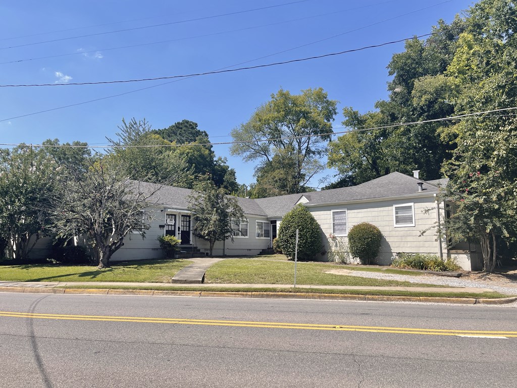 a white house on the corner of a street