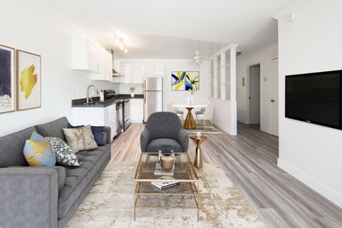 A living room with a grey couch and a coffee table.