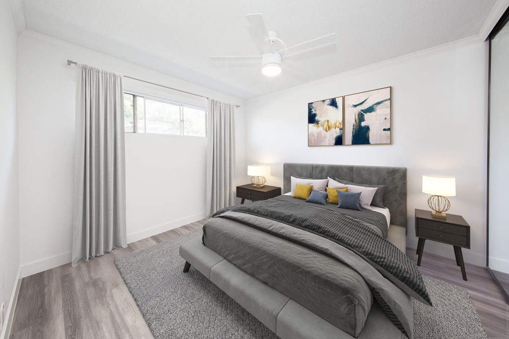 Bedroom furnished with bed, side tables, lamps and wall hangings