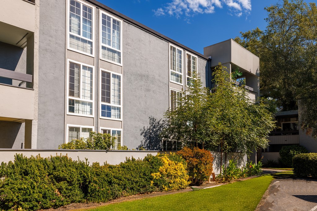 A modern building with a well-maintained lawn in front.