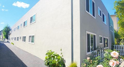 a large white building with flowers in front of it