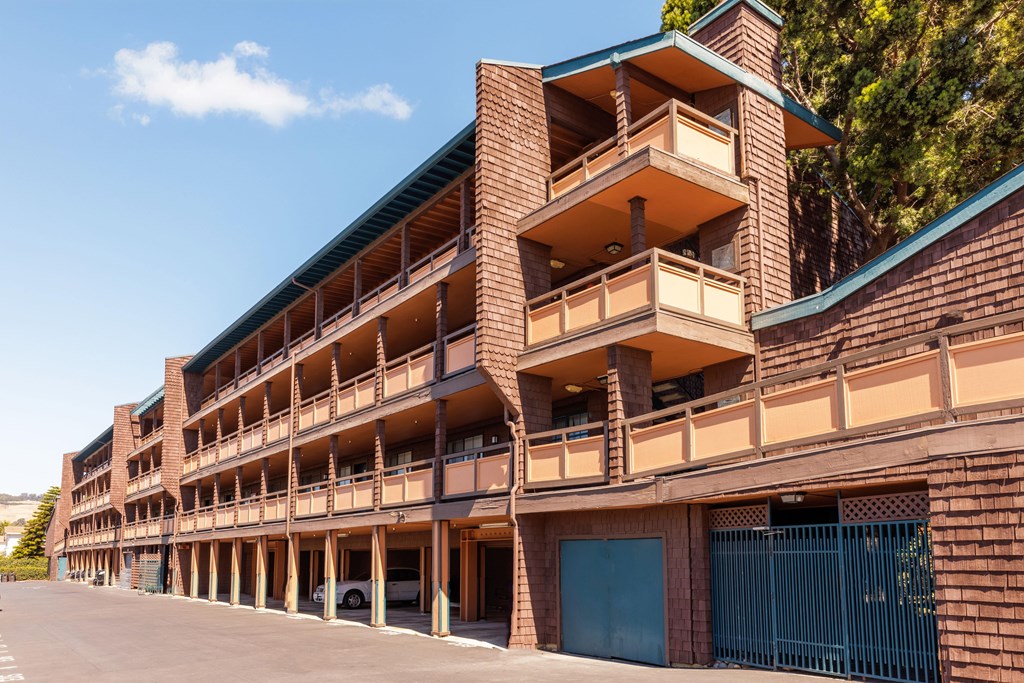 A large multi-story parking garage with a blue sky in the background.