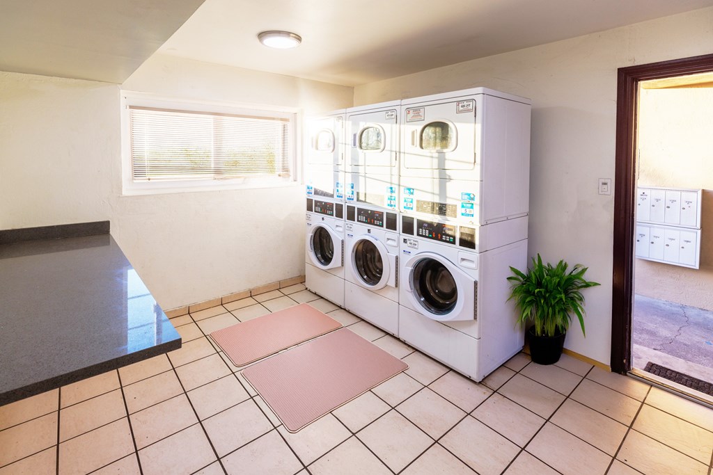 A laundry room with a washing machine and dryer stacked on top of each other.