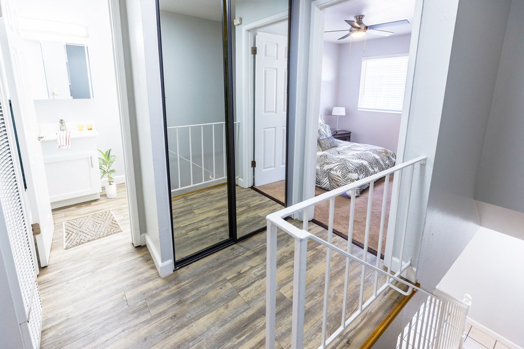 A bedroom with a bed and a ceiling fan.