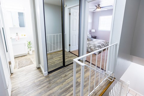 A bedroom with a bed and a ceiling fan.