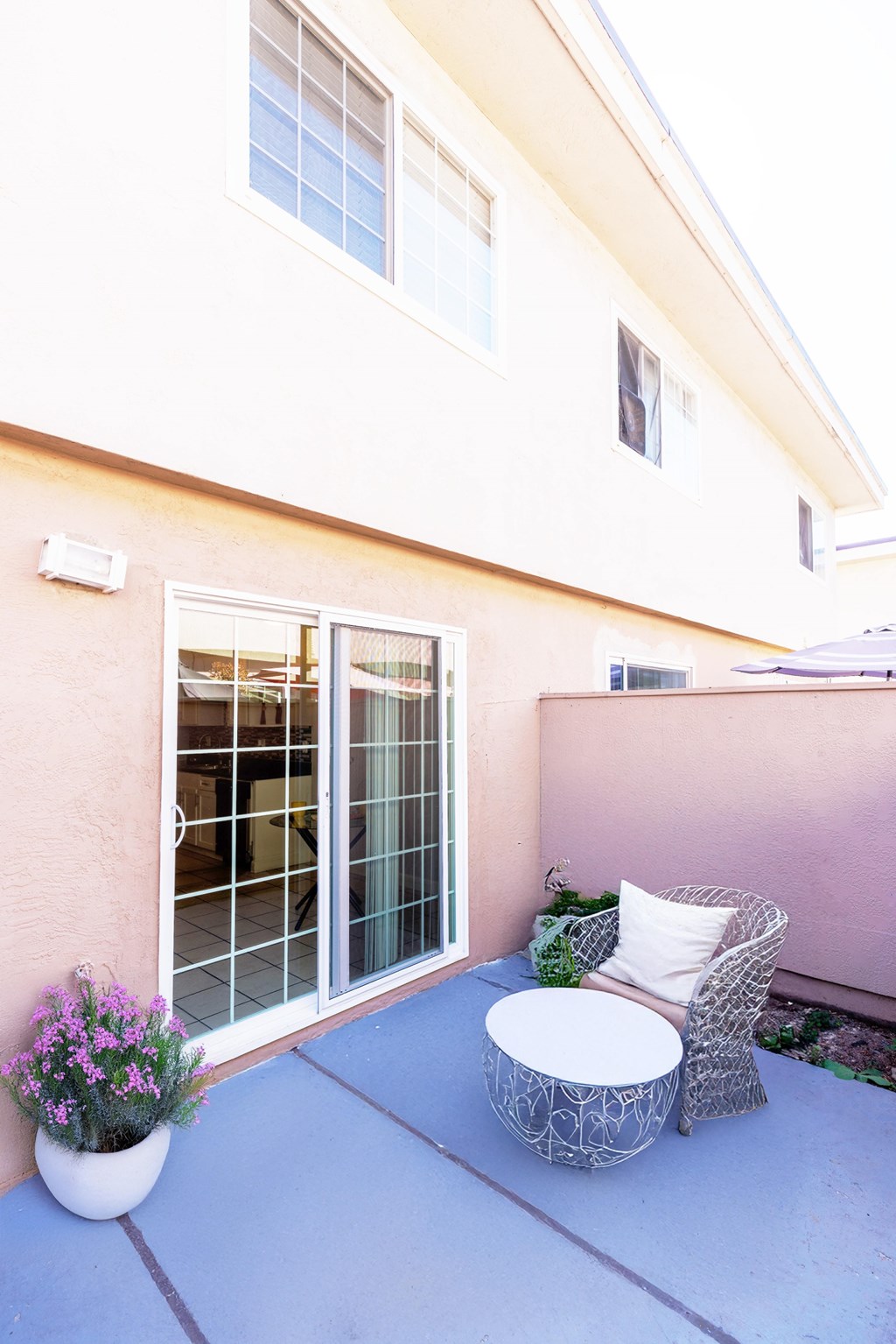 A patio with a chair and table.