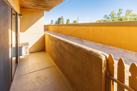 A sunny day at a modern house with a balcony.