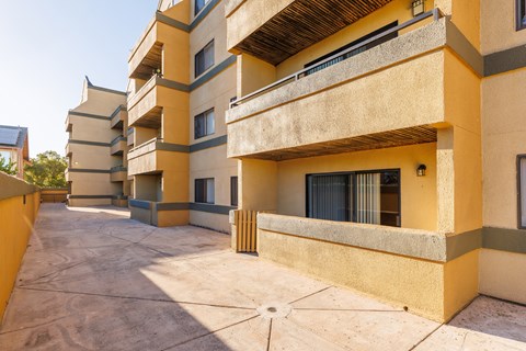 A sunny day at a courtyard surrounded by buildings.