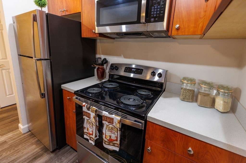 A black stove top oven with two pot lids on it.