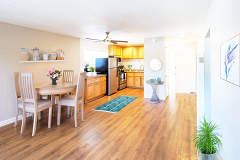 A dining room with a table and chairs.