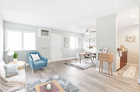 A living room with a blue chair and a white couch.