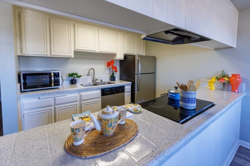 a kitchen with white cabinets and a counter top