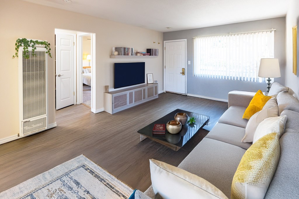 A living room with a grey couch and a coffee table.