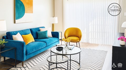 A living room with a blue couch, a yellow chair, and a coffee table.