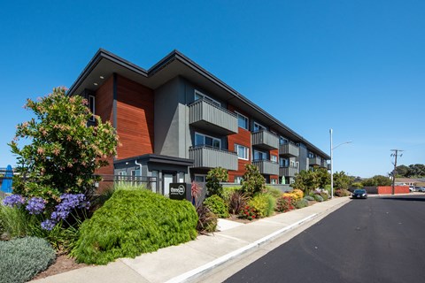 a modern apartment building with a street in front of it