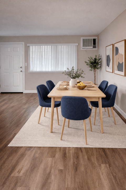 A dining room with a table set for six.