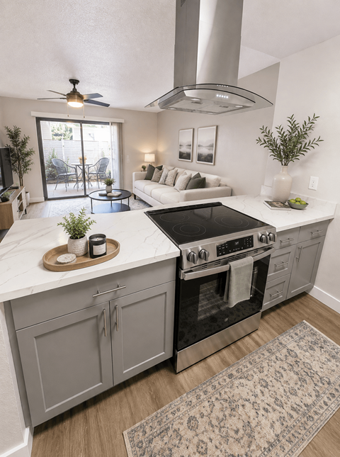 A modern kitchen with a black stove top oven and a marble counter top.