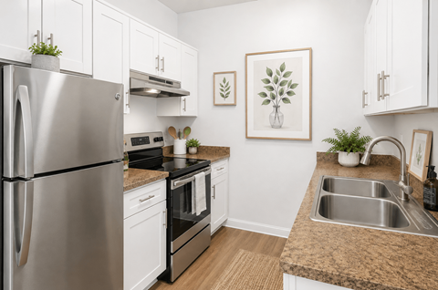 A modern kitchen with a stainless steel refrigerator and a sink.