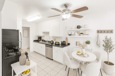 A modern kitchen with a dining table and chairs.